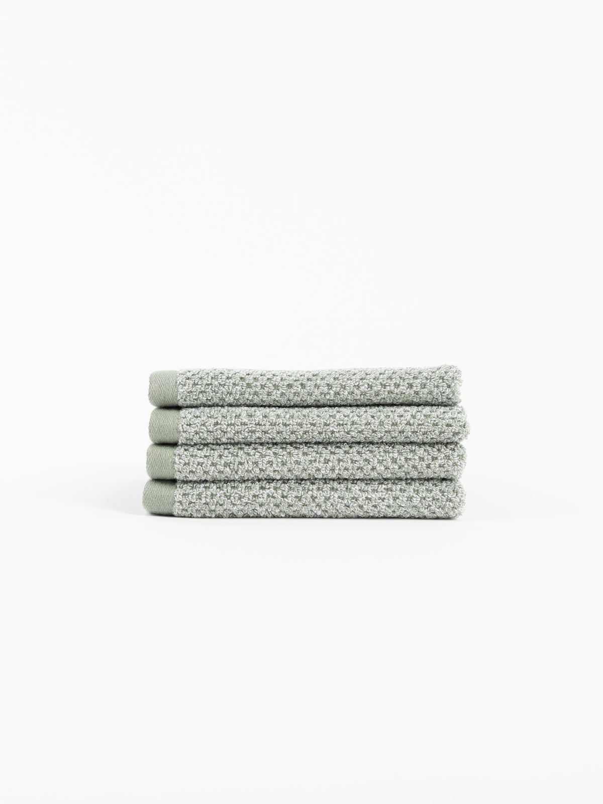 A stack of four Nantucket Washcloths in Heathered Sage sit in front of a white background. |Color:Heathered Sage