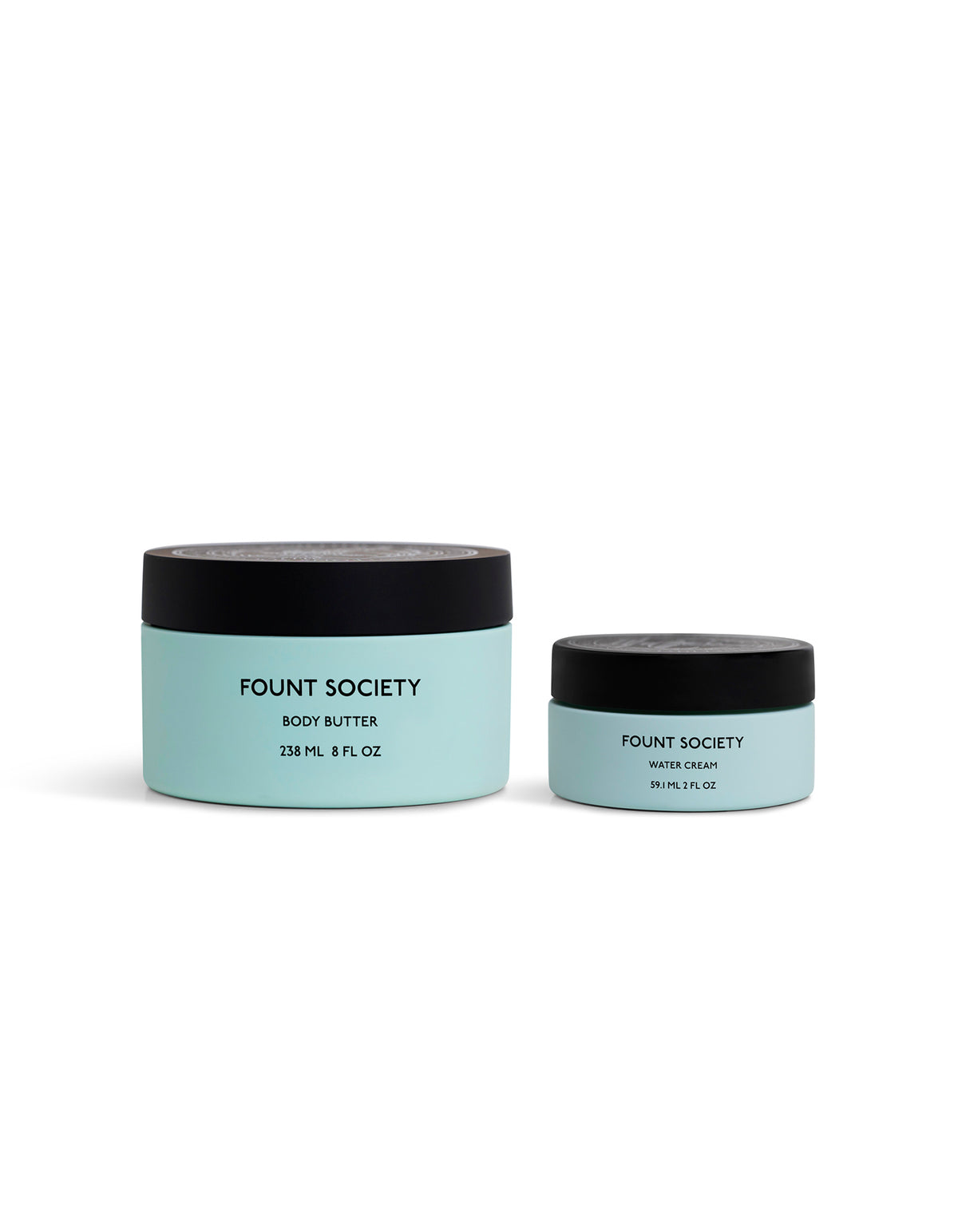 Two light blue jars with black lids from Cozy Earth, called the Dewy Duo. The larger jar is labeled Body Butter and the smaller Water Cream. Both feature a minimalistic, modern design.