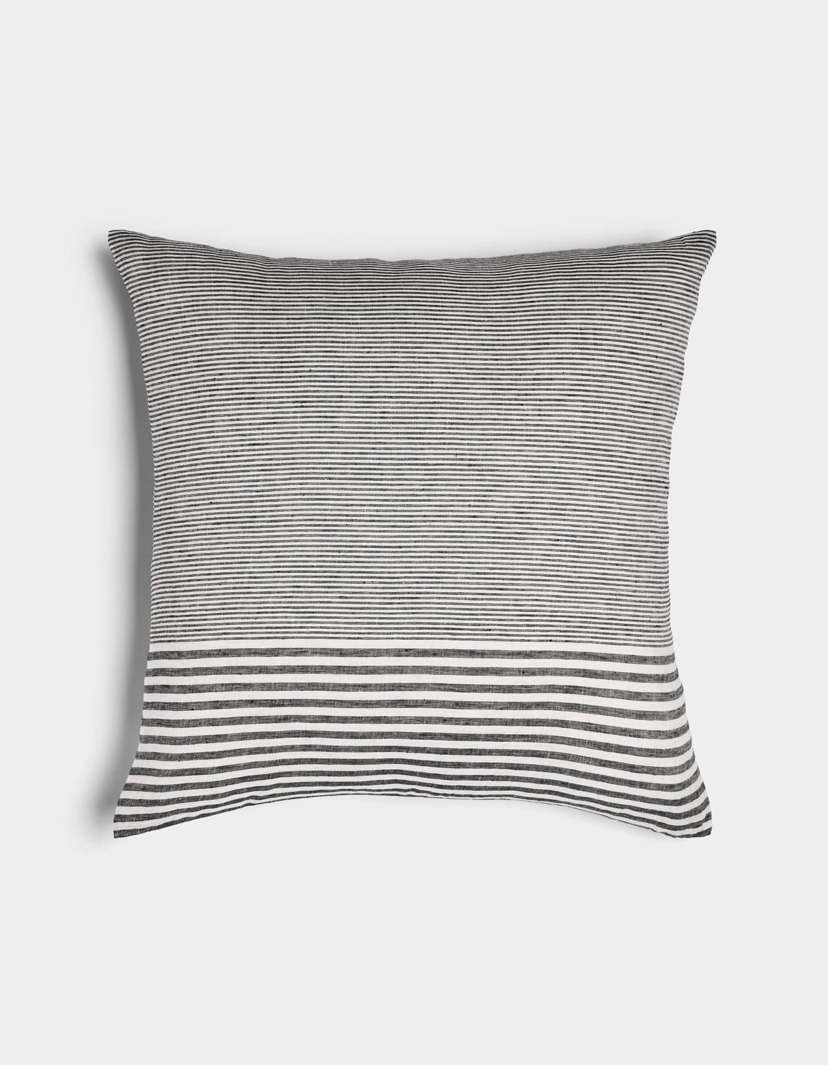 The Cozy Earth Striped Throw Pillow features thin black and white horizontal stripes with a wider striped band near the bottom, displayed on a plain white background.|Color:Mixed Stripe Eclipse and Sea Salt |Size:24" x 24"