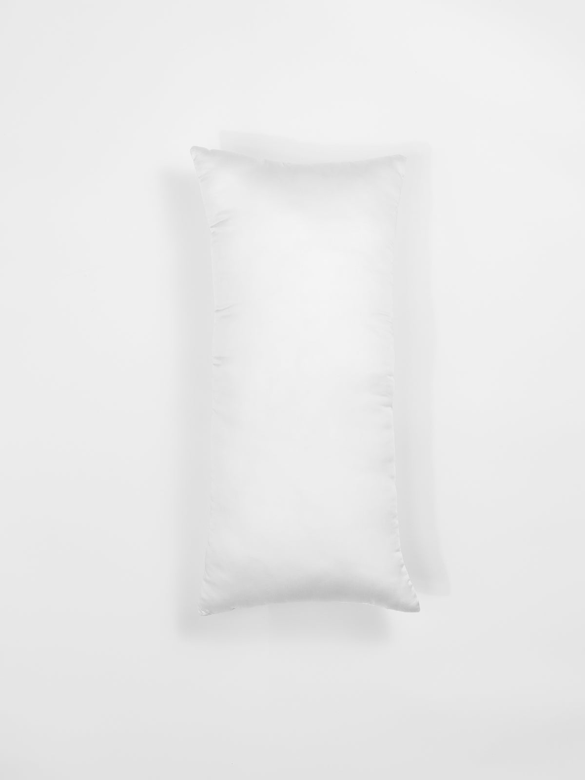 A white rectangular pillow from Cozy Earth's Premium Down Alternative Insert collection against a plain white background. The pillow sports a clean and simple design, featuring a smooth surface with faint seams visible along the edges. 