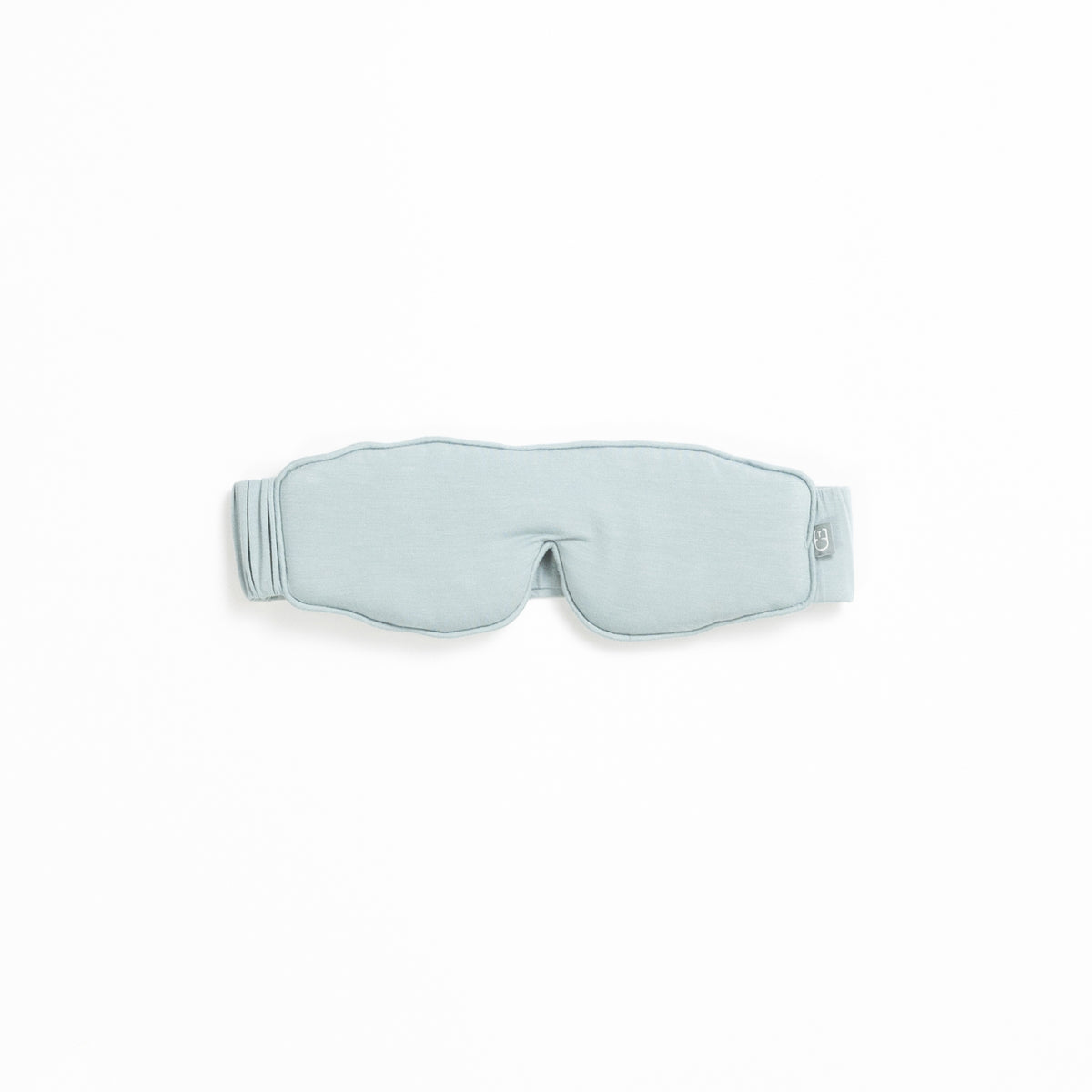 A light gray sleep mask from the Rest & Reset Bundle by Cozy Earth, featuring an adjustable strap, displayed on a white background.