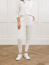 Ivory Bamboo Jogger Set modeled by a woman. The photo was taken in a high contrast setting, showing off the colors and lines of the pajamas. |Color: Ivory
