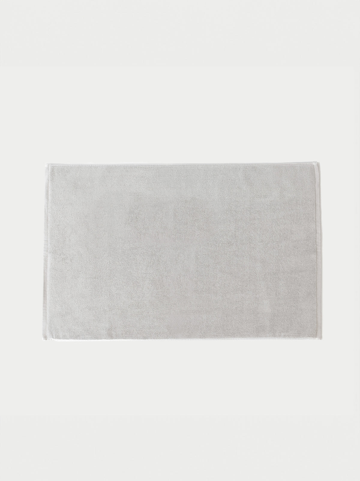 The Cozy Earth Loop Terry Bath Mat features a rectangular, light gray solid design, shown placed on a white background.|Color:Light Grey
