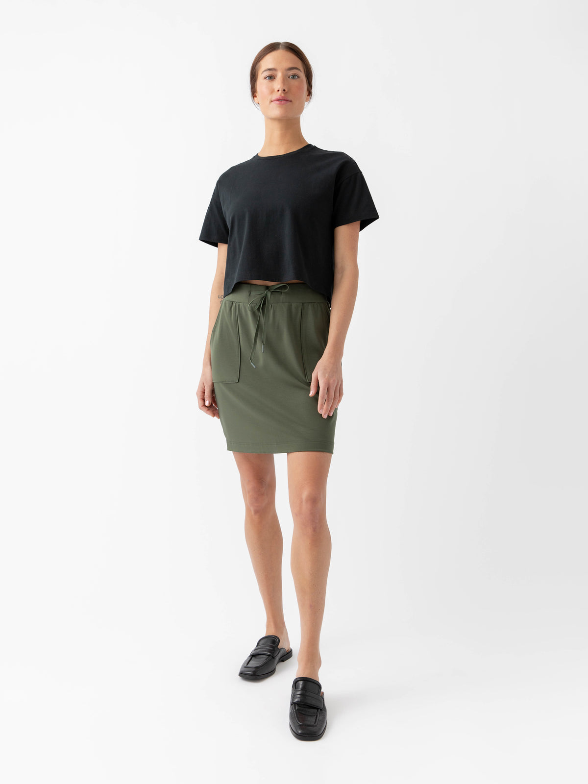 Person wearing a Cozy Earth Brushed Bamboo Patch Pocket Skirt in green on a white background 