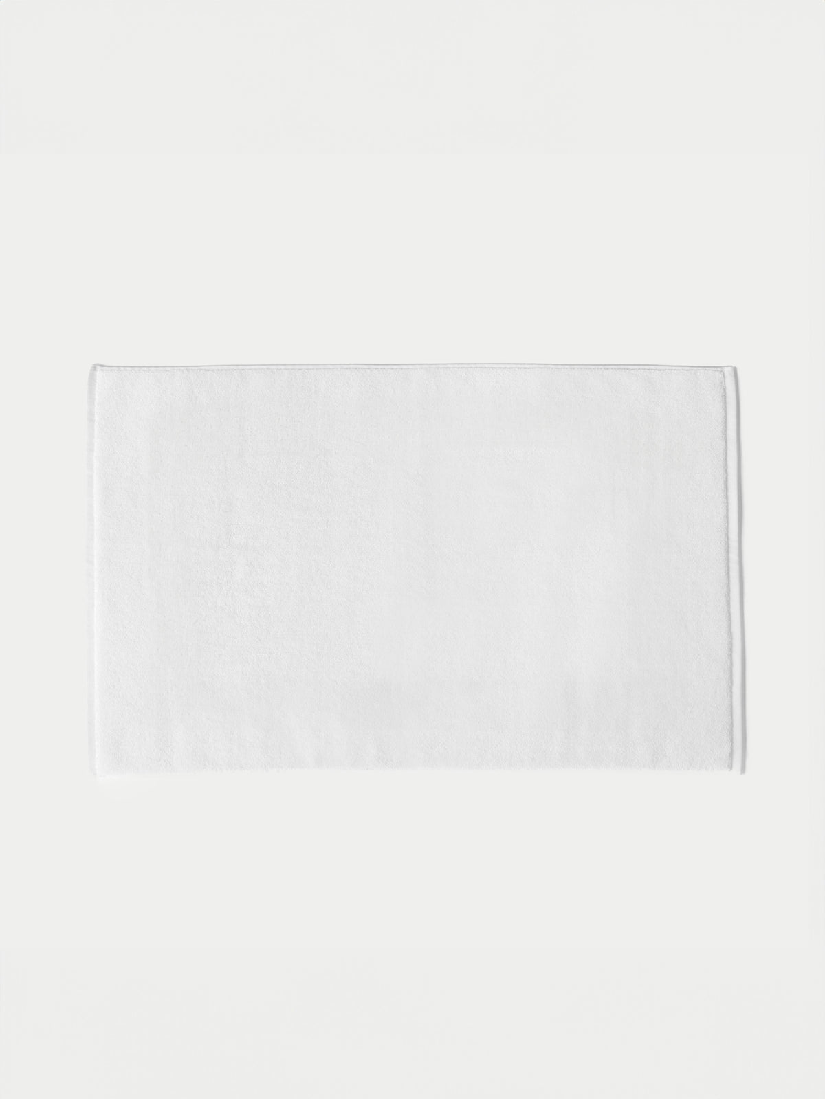 The Cozy Earth Loop Terry Bath Mat, featuring a plain white rectangular design, is displayed on a white background.|Color:White