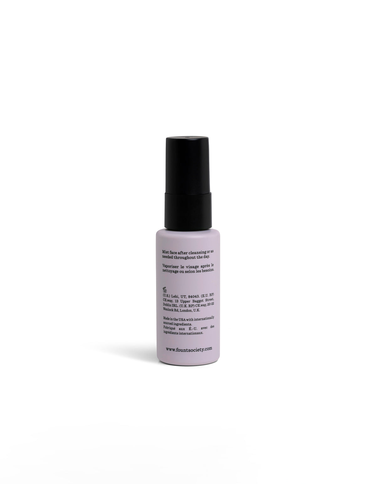 A small, white spray bottle facing backwards with a black cap and circular logo stands upright on a white background. 
