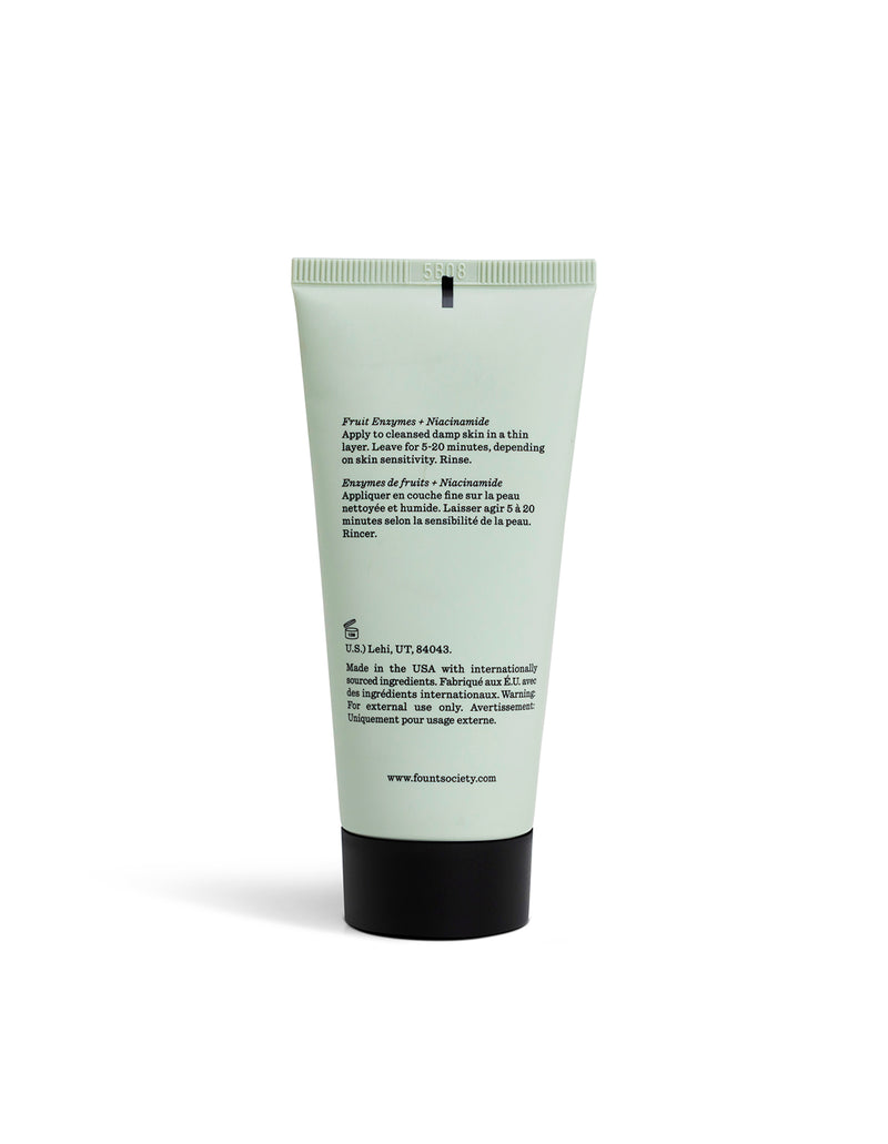 A light green tube of Cozy Earth Enzyme Mask stands upright against a white background, featuring black text on the back with ingredients and usage instructions.
