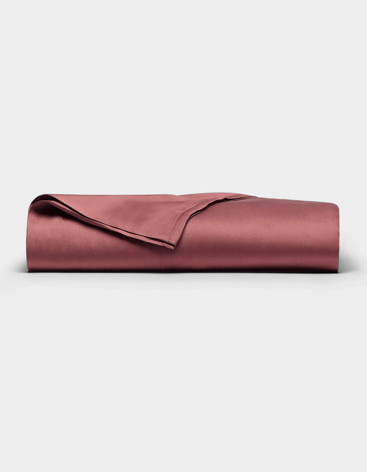 A Cozy Earth Bamboo Flat Sheet in a rose color is neatly folded and displayed on a plain white background. 