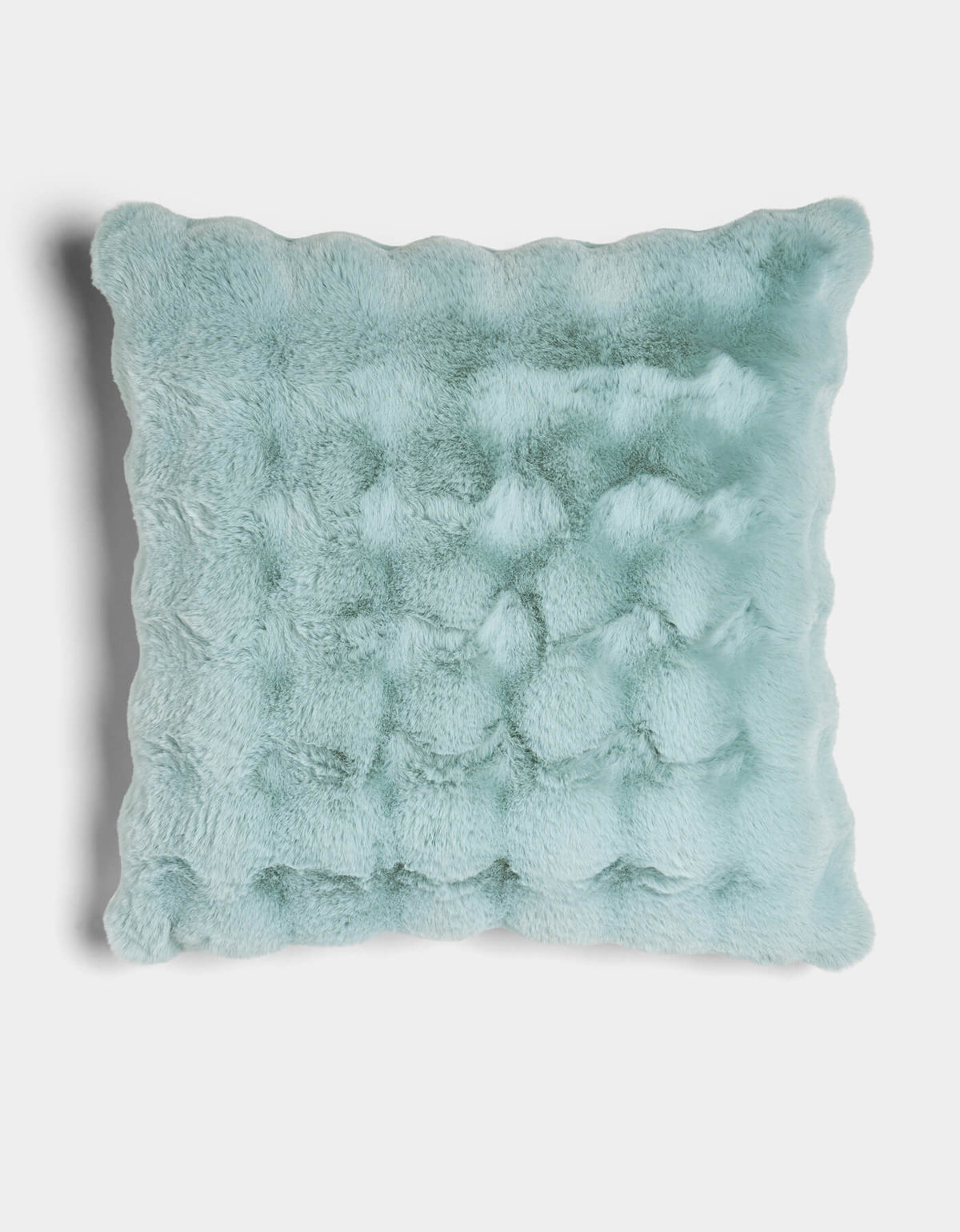 The Bubble Cuddle Pillow by Cozy Earth is a square, light blue faux fur pillow with a plush, textured surface and wavy scalloped edges, shown against a white background.