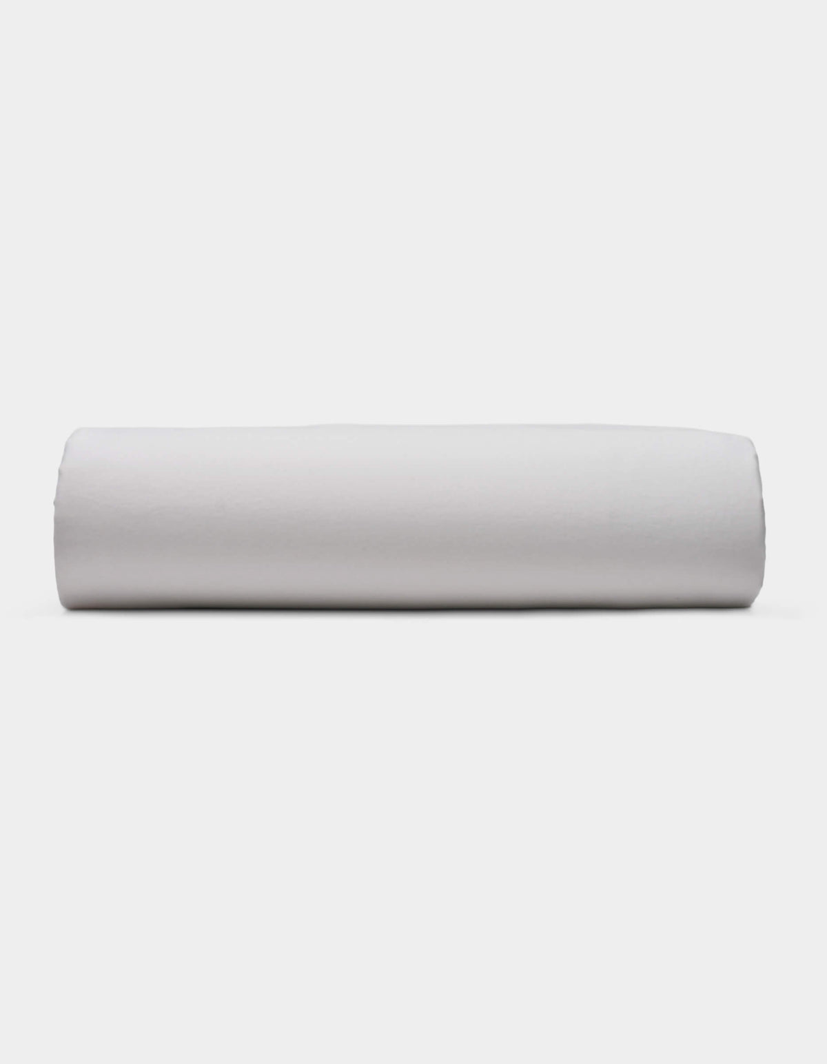 A Soft-Wash Cotton Fitted Sheet by Cozy Earth is displayed lying flat on a light surface with a neutral background.