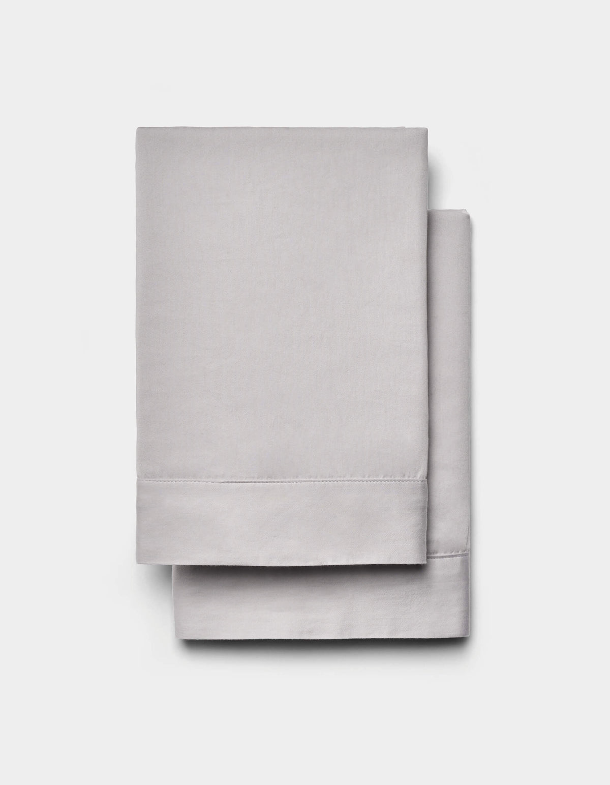 Two neatly folded Cozy Earth Soft-Wash Cotton Shams in light gray are stacked atop each other against a plain white background.