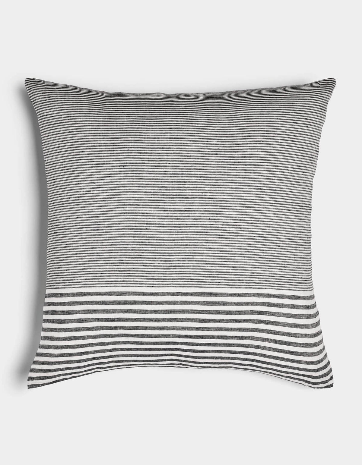 The Cozy Earth Striped Throw Pillow features thin black and white horizontal stripes with a bold, wider band at the bottom on a plain white background.