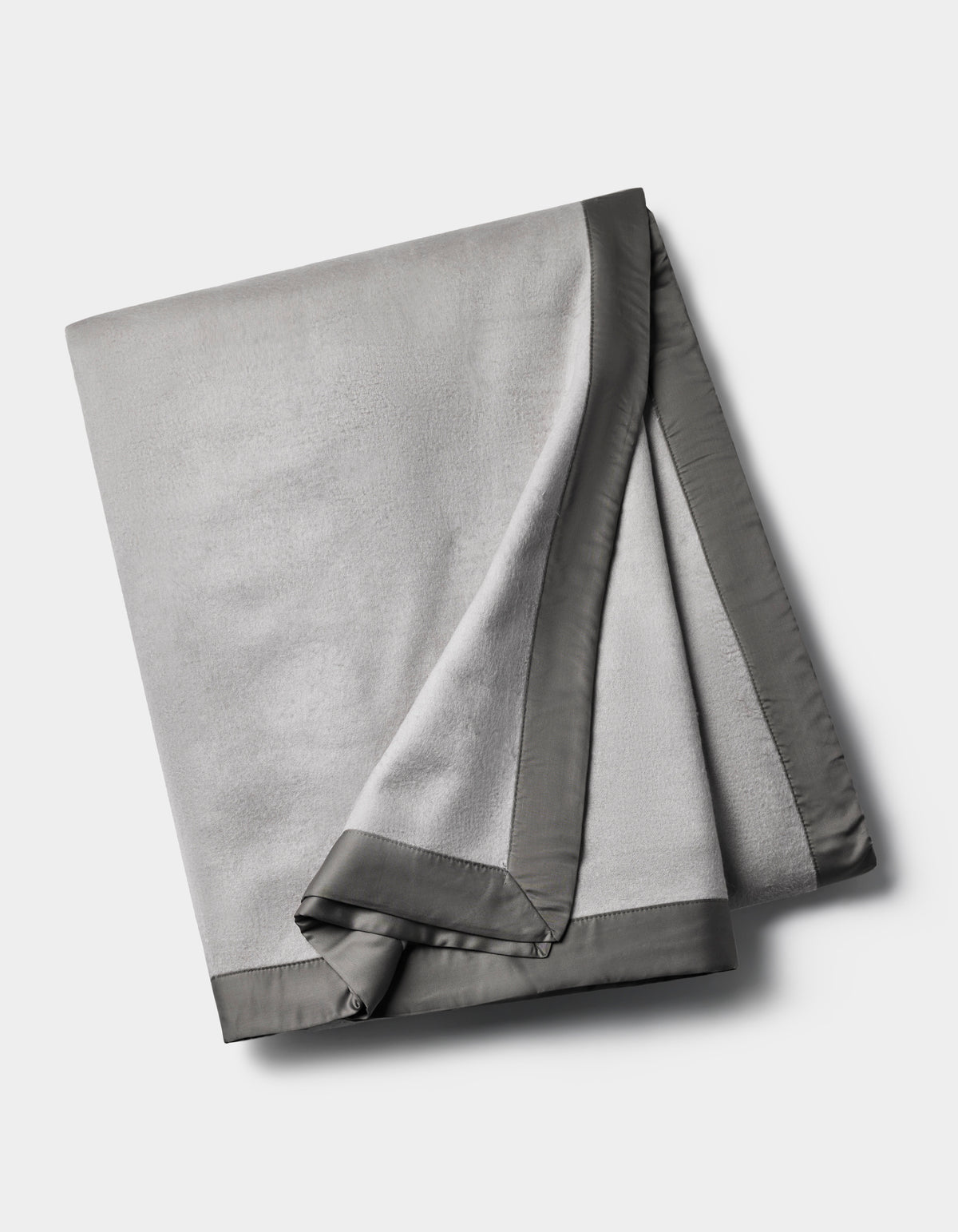 The Cozy Earth Bamboo Blanket is a folded light gray fleece with a smooth, dark gray satin border, shown on a plain white background.|Color:Dove Grey/Charcoal
