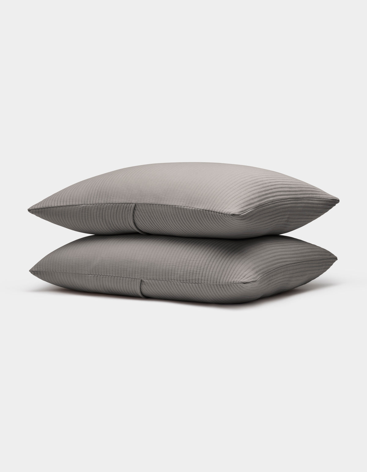 Two neatly stacked Bamboo Coverlet Shams by Cozy Earth in gray with stripes, displayed on a plain white background.