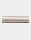 A Cozy Earth Bamboo Fitted Sheet in plain, light beige is shown lying horizontally on a white background, viewed from the side.|Color:Driftwood