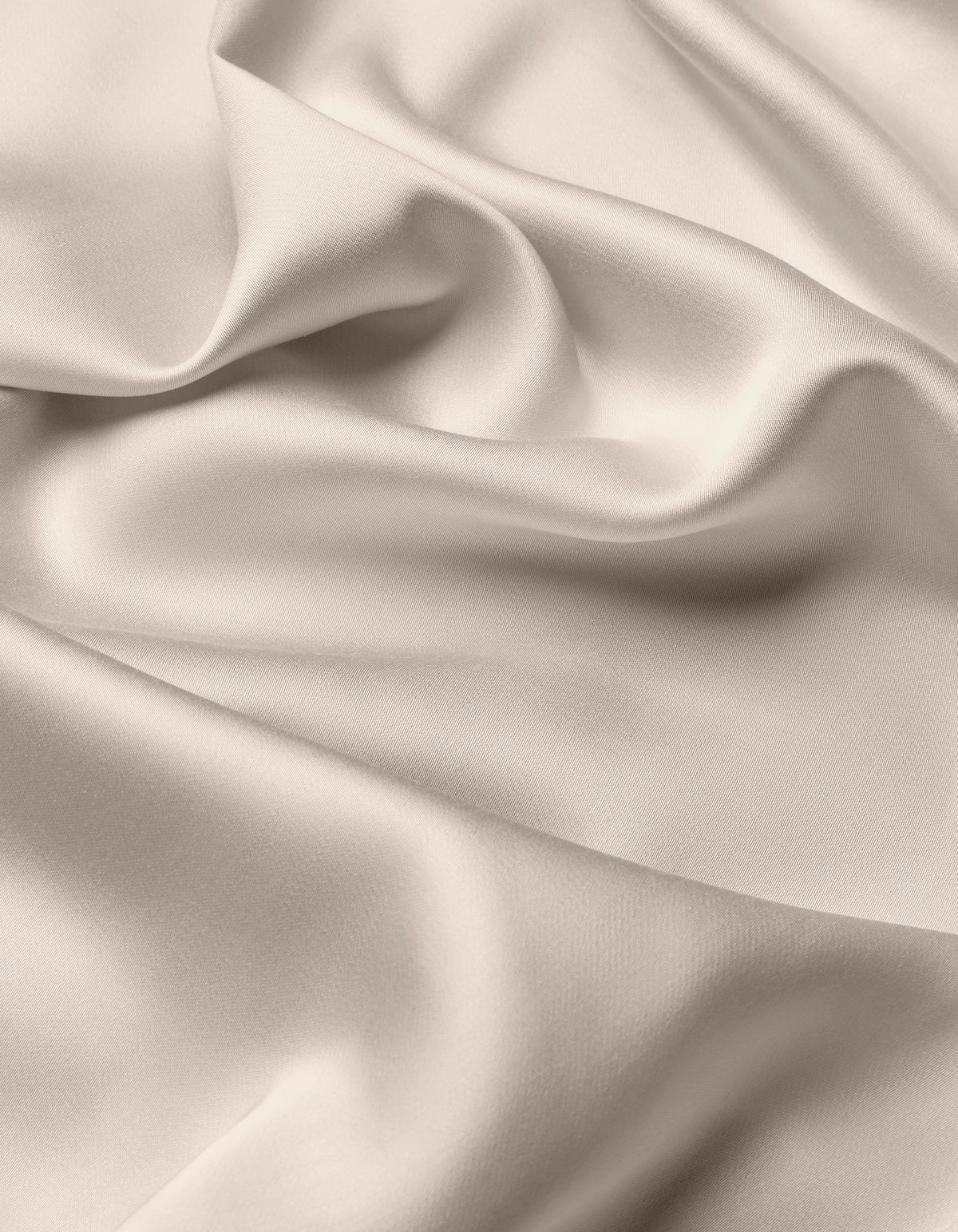 The Cozy Earth Bamboo Flat Sheet features a smooth, light-colored fabric with soft folds and gentle draping, creating a silky, elegant texture.