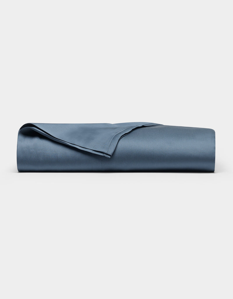 The Cozy Earth Bamboo Flat Sheet, neatly folded and smooth in navy blue, is displayed against a plain white background.