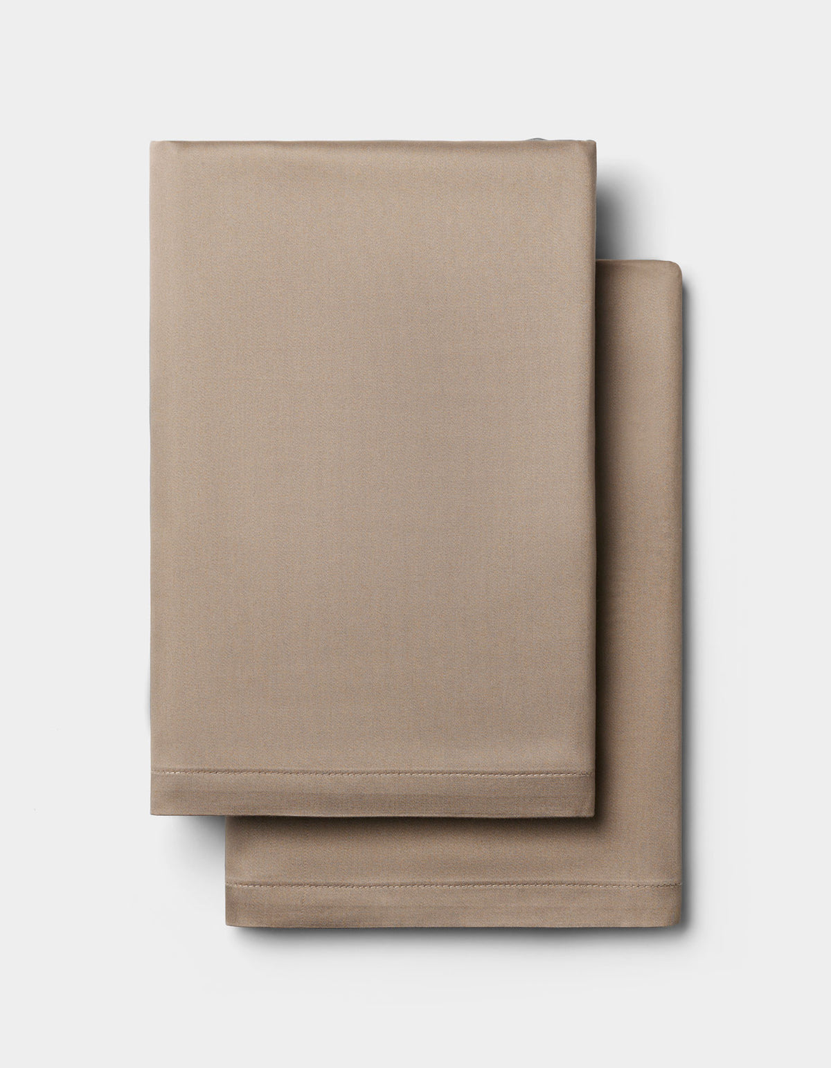 Two neatly folded Cozy Earth Bamboo Pillowcases are stacked on a plain white background.