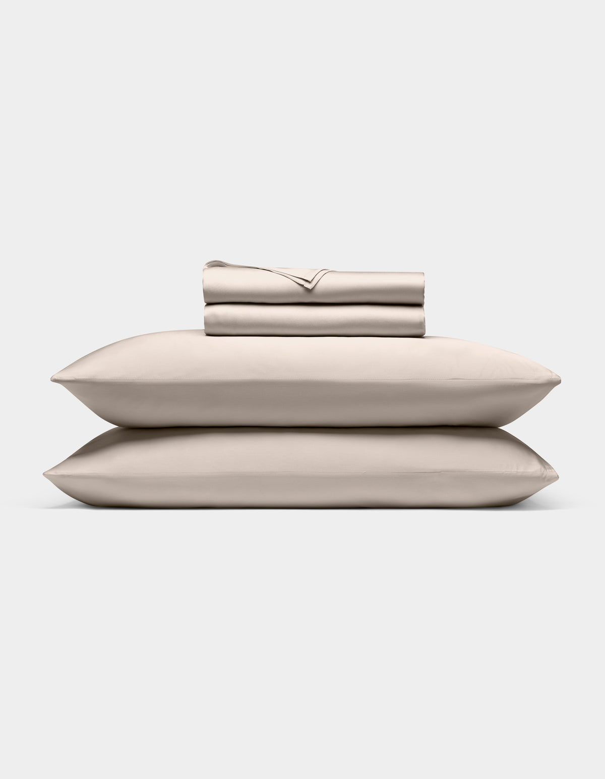 A neatly stacked Cozy Earth Bamboo Sheet Set, featuring two pillows, a folded fitted sheet, flat sheet, and pillowcases, displayed against a plain white background.|Color:Driftwood