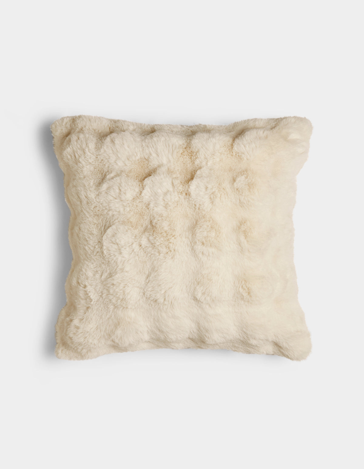 The Bubble Cuddle Pillow by Cozy Earth is a square, cream-colored pillow with a soft, fur-like texture, displayed against a plain white background.|Color:Creme |Size:24" x 24"