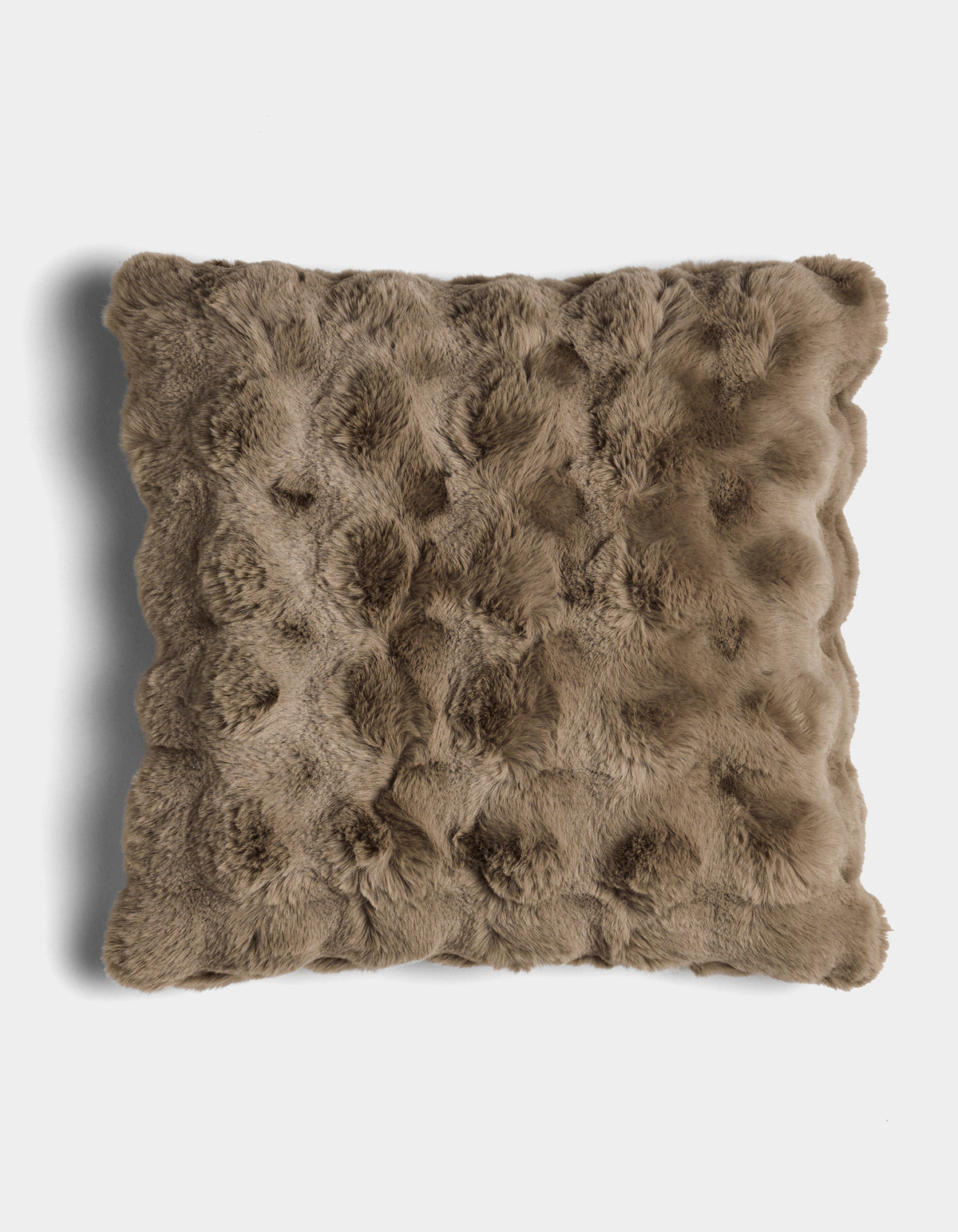 The Bubble Cuddle Pillow by Cozy Earth is a square, brown faux fur pillow with a textured, tufted surface, shown against a white background.