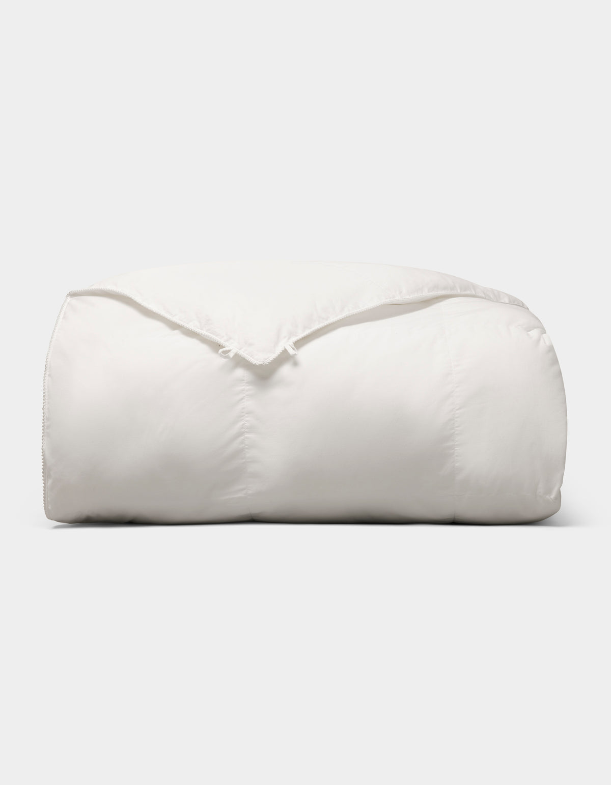 The Cozy Earth Down Alternative Comforter is neatly folded and fluffy, displayed against a plain light gray background. 