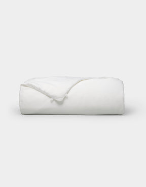 The Cozy Earth Silk Comforter is neatly folded with a corner turned down, showcased against a plain white background.|Filling:Standard