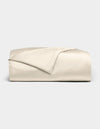 The Cozy Earth Bamboo Duvet Cover is shown neatly folded in light beige, with one corner turned back, set against a plain light gray background.|Color:Creme
