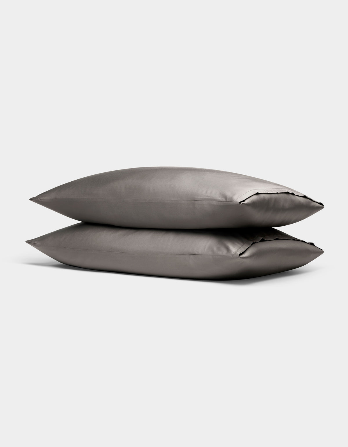 Two Cozy Earth Bamboo Pillowcases in gray are stacked together against a plain light background.