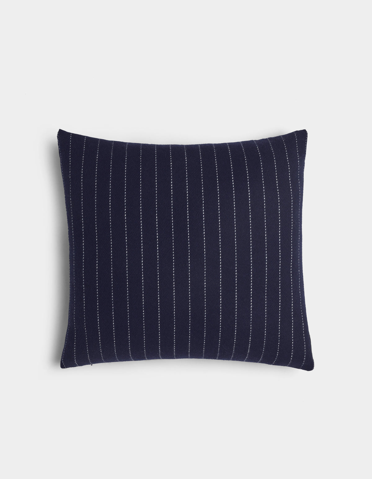 The Florence Pillow by Cozy Earth is a rectangular navy blue pillow with vertical white pinstripes, shown on a plain white background.