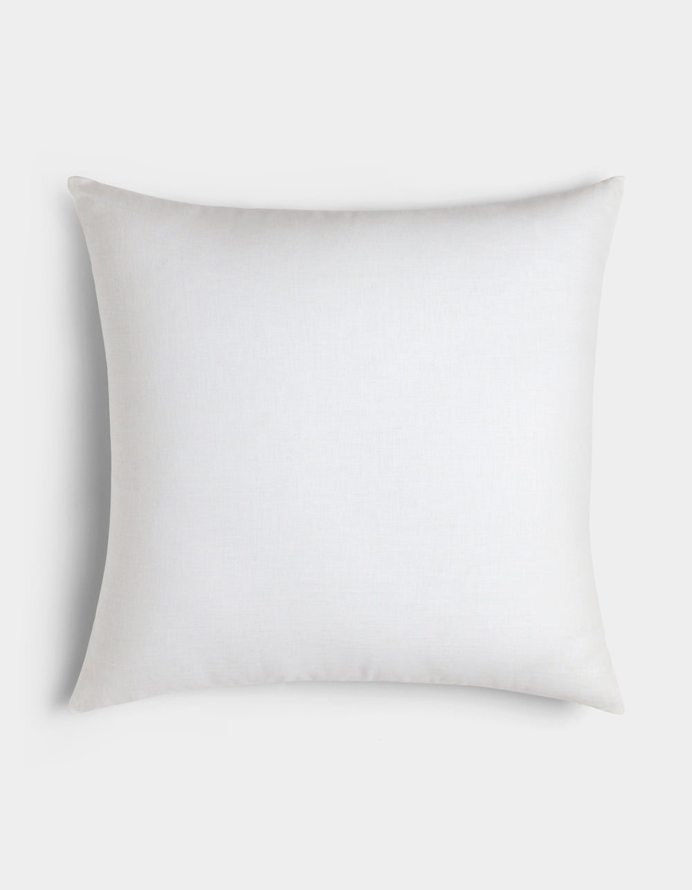 The Cozy Earth Linen Throw Pillow is a plain, square white pillow with smooth fabric, displayed from above on a light gray background.