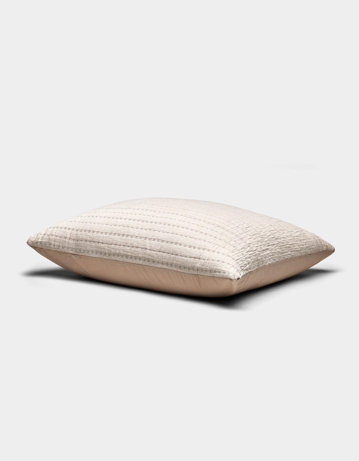 The Baja Matelasse Sham by Cozy Earth is a beige, rectangular pillow sham featuring a textured, quilted design, shown on a plain white background.|Color:Ebony/Taupe