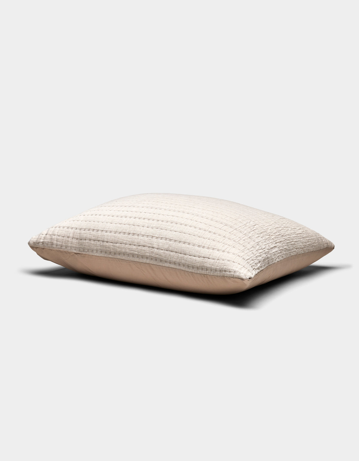 The Cozy Earth Baja Matelasse Sham is a beige, rectangular pillow sham with a textured quilted pattern, shown against a plain white background. The fabric appears soft and slightly puffed.