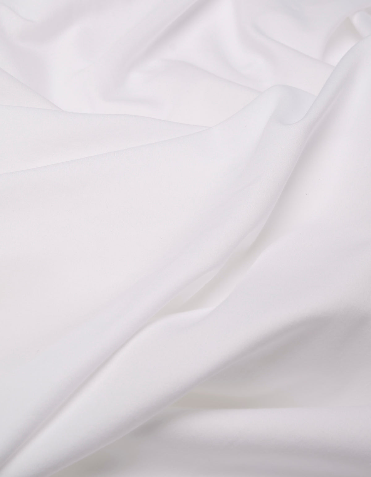 A close-up of the Cozy Earth Soft-Wash Cotton Duvet Bundle shows its soft, white fabric with gentle folds and a smooth texture, creating a calm and clean appearance.