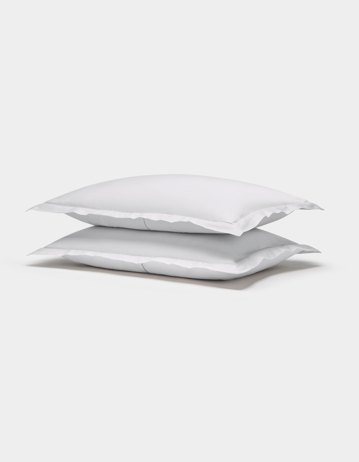 Two Cozy Earth Soft-Wash Cotton Shams are stacked neatly on top of each other against a plain white background.|Color:White