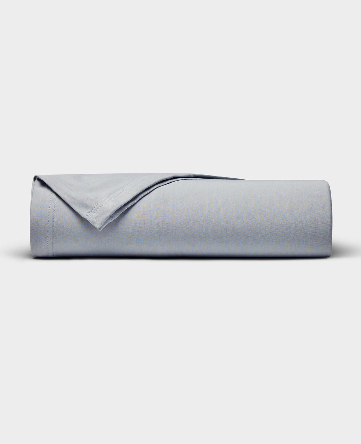 The Cozy Earth Bamboo Jersey Flat Sheet is neatly rolled with a folded edge and displayed on a plain white background.