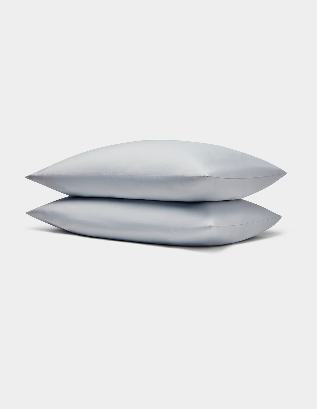 Two light gray Bamboo Jersey Pillowcases by Cozy Earth stacked neatly on each other against a plain white background.