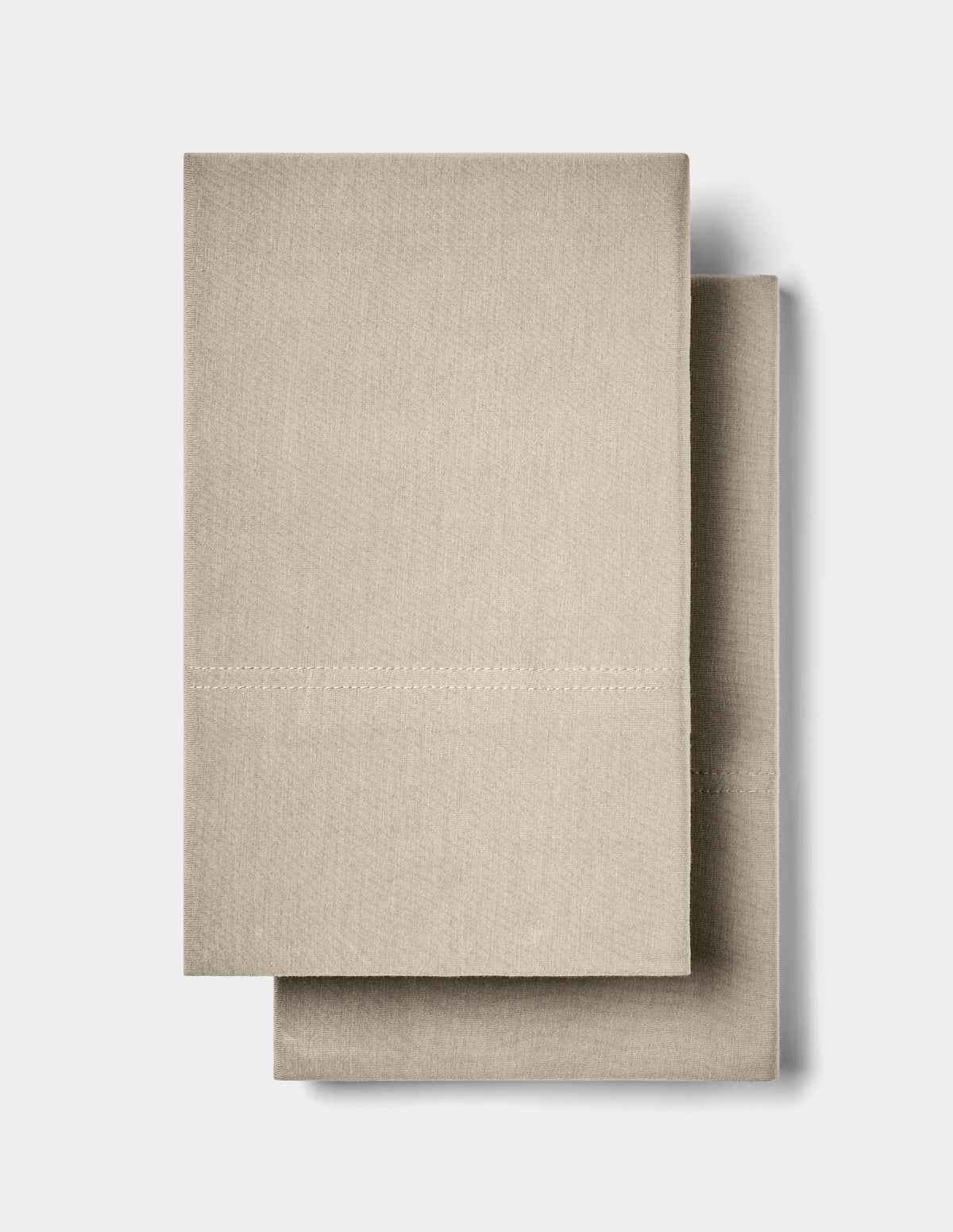 Two neatly folded Cozy Earth Bamboo Jersey Pillowcases are stacked together against a plain white background.|Color:Driftwood
