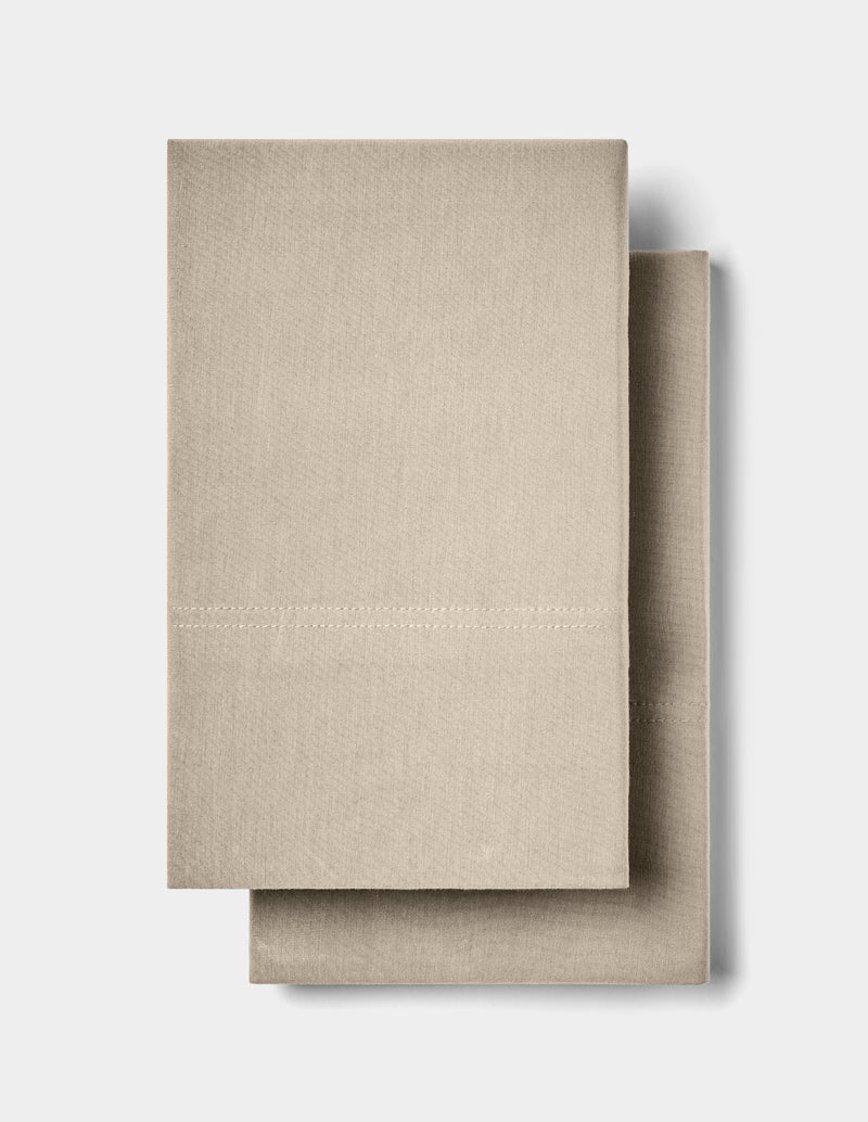 Two neatly folded Cozy Earth Bamboo Jersey Pillowcases are stacked together against a plain white background.
