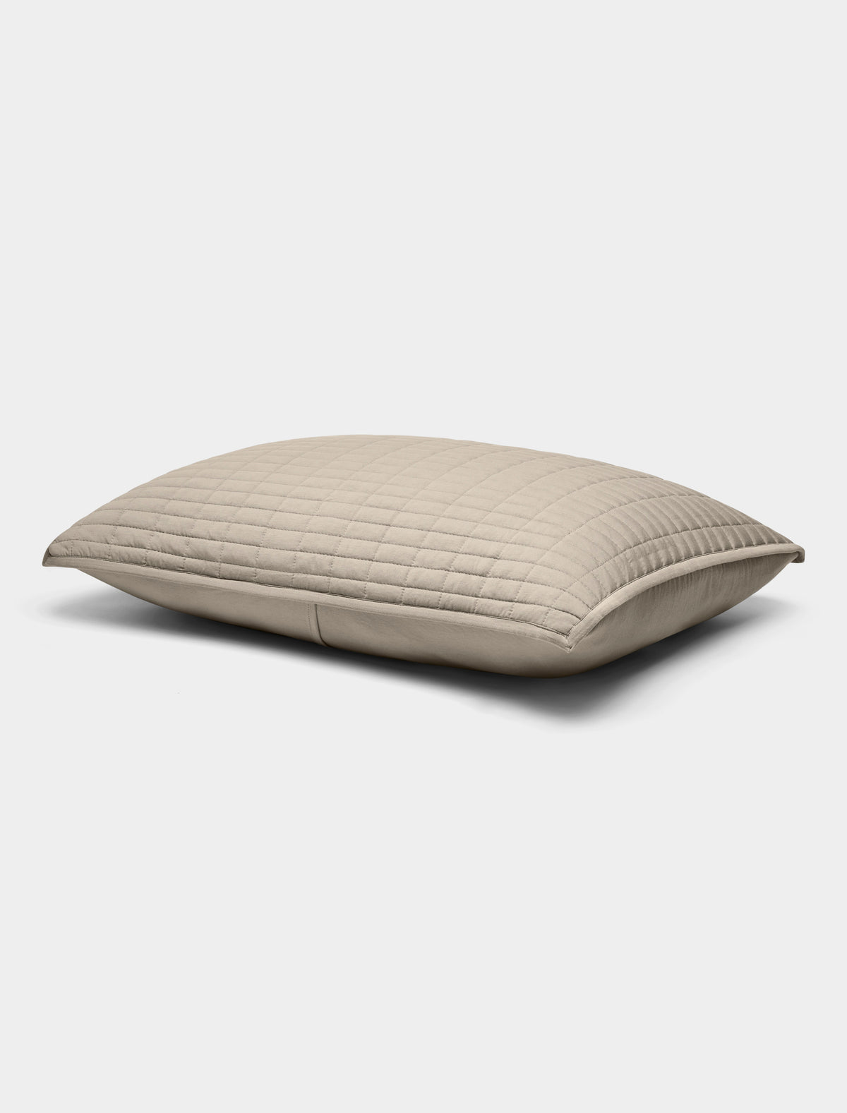 The Bamboo Jersey Quilted Shams by Cozy Earth are beige, rectangular pillows featuring a quilted pattern, displayed against a plain white background.|Color:Driftwood
