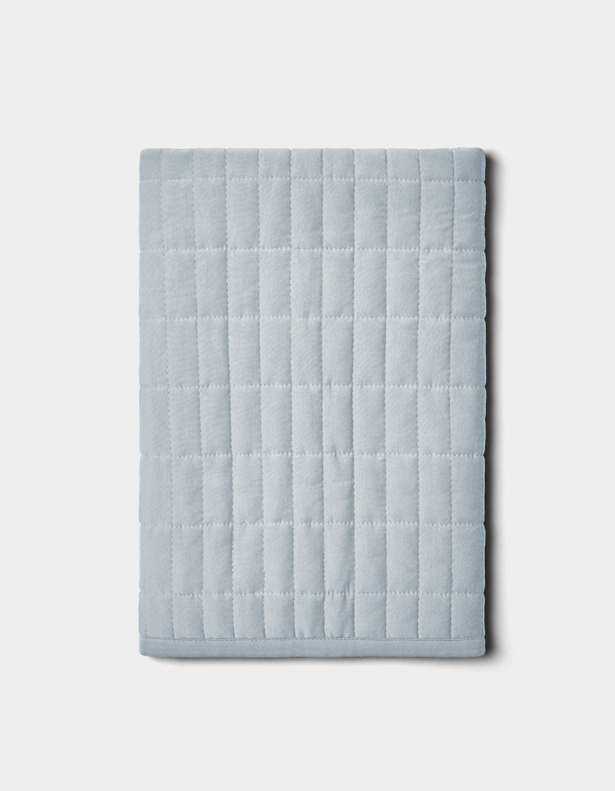 The Cozy Earth Bamboo Jersey Quilted Shams feature a folded, light gray design with a square grid pattern, shown on a plain white background.