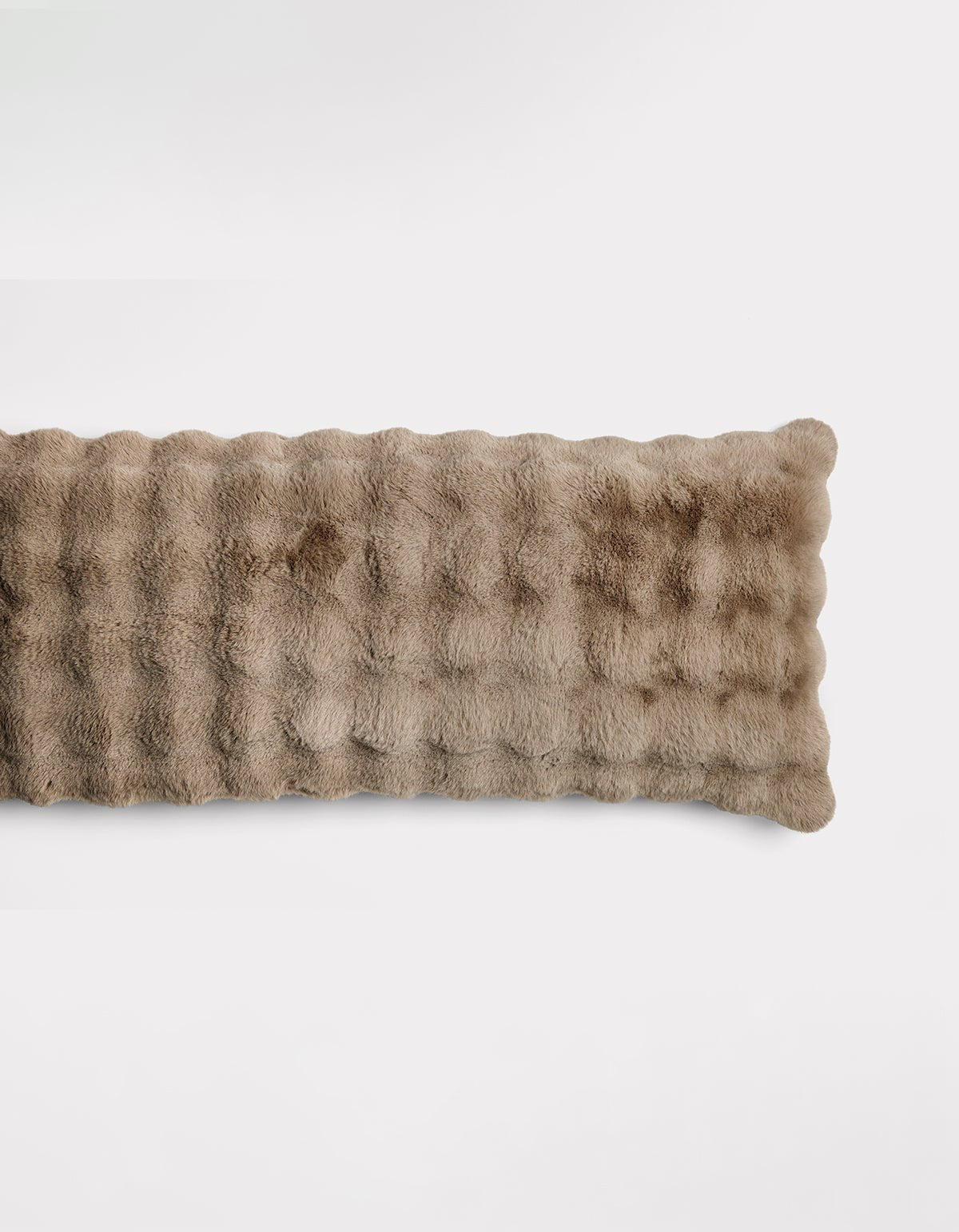 The Bubble Cuddle Pillow by Cozy Earth is a rectangular, light brown pillow with a soft, plush, furry texture, shown against a plain white background.
