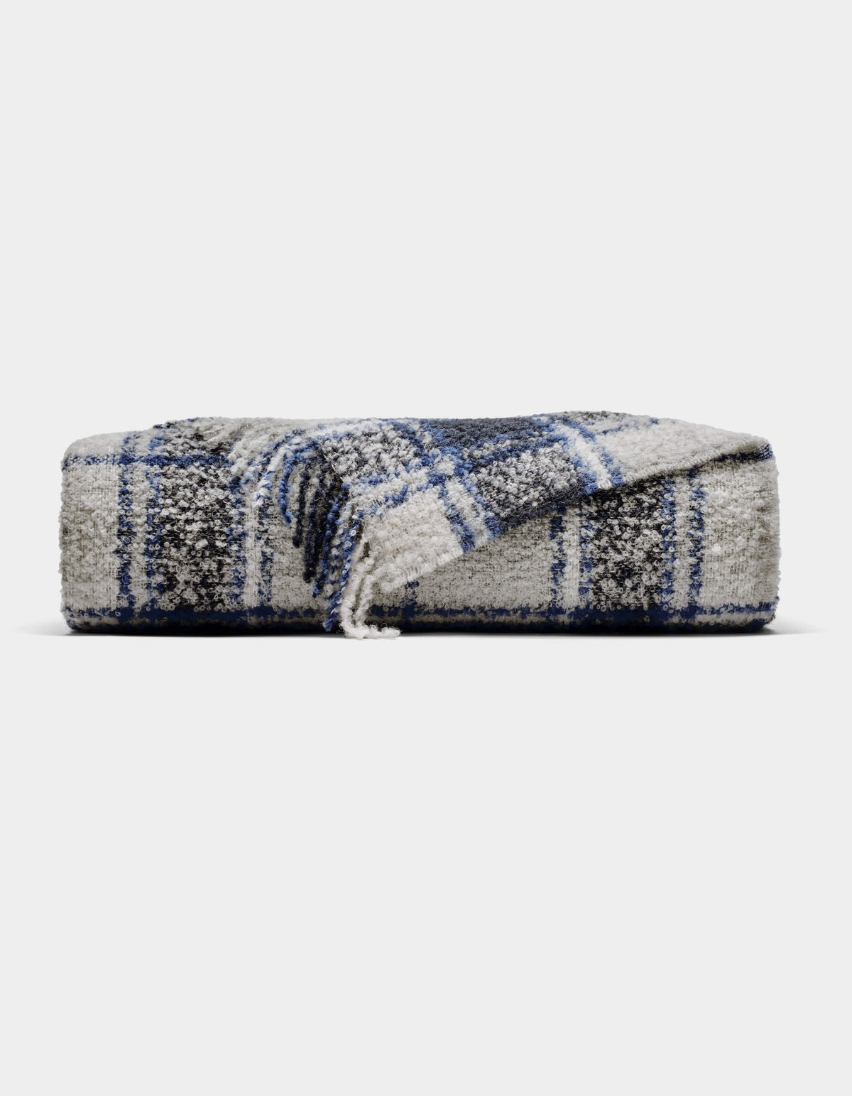 The Cozy Earth Alpaca Boucle Throw is a soft, gray blanket with a blue and white plaid pattern. Displayed against a plain background, one corner is partially unfolded to showcase its unique texture and design.