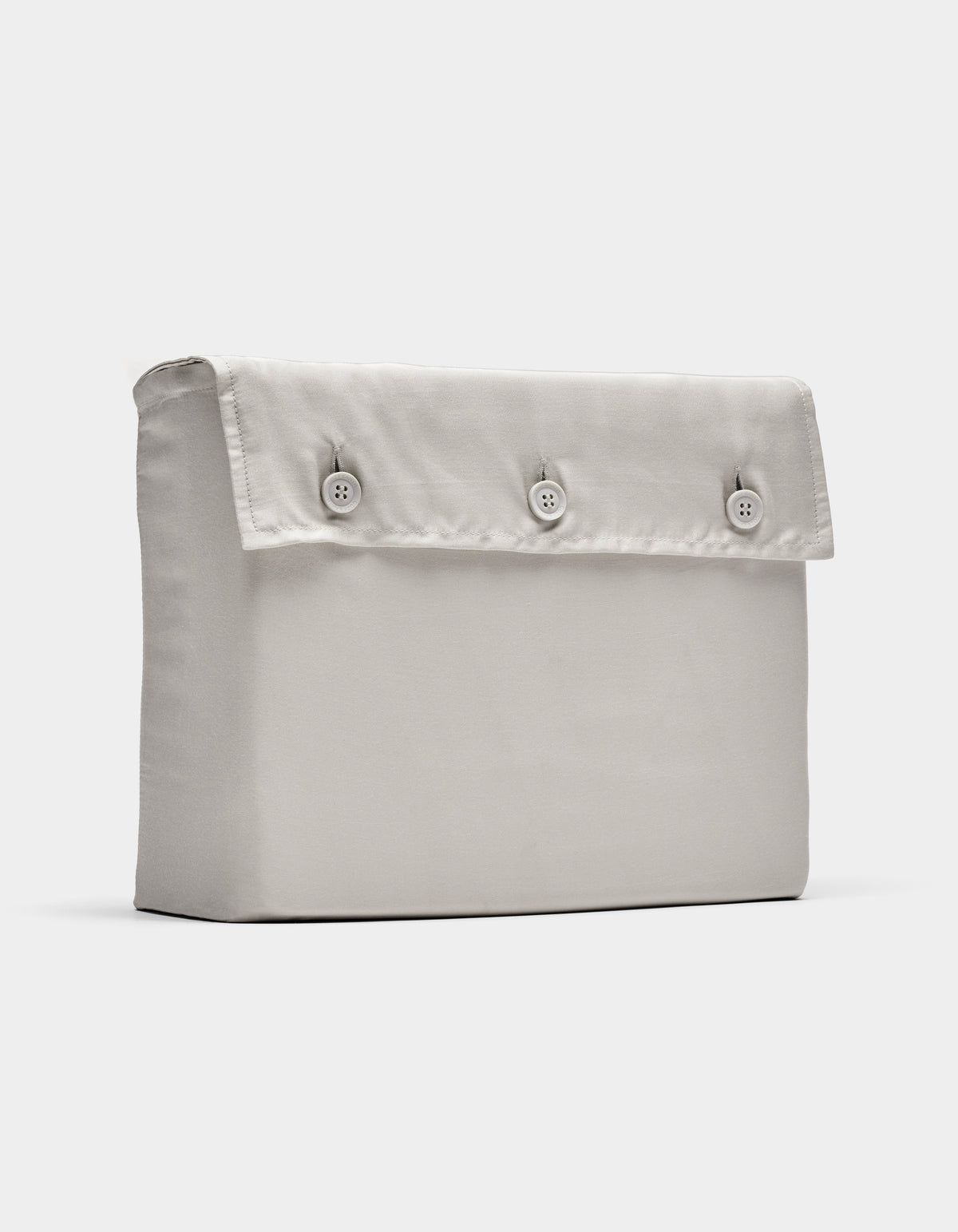 The Cozy Earth Bamboo Sheet Set, shown in light beige, is displayed folded with a rectangular fabric pouch and flap secured by three front buttons, photographed against a plain white background.