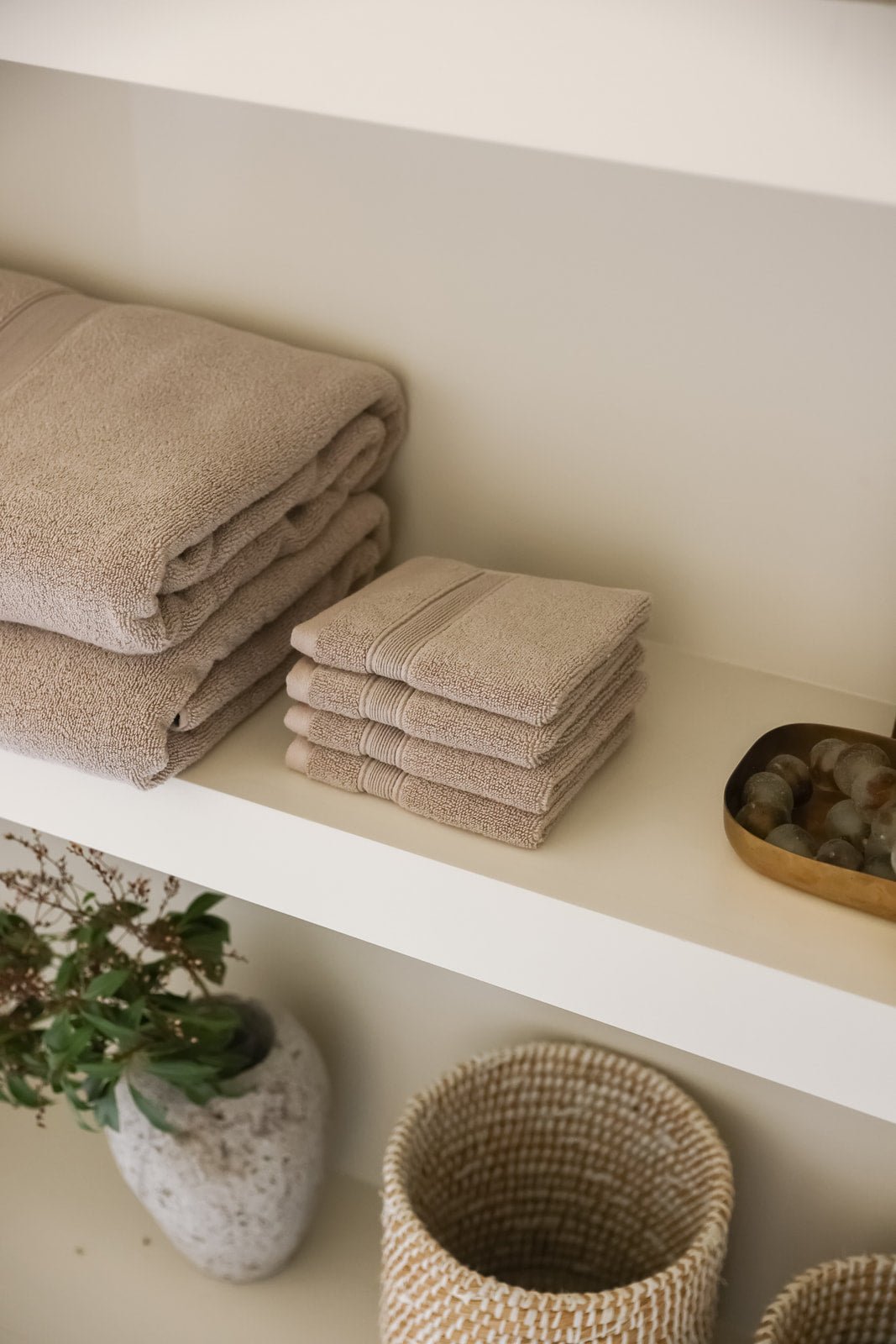 Sand washcloths folded on counter 