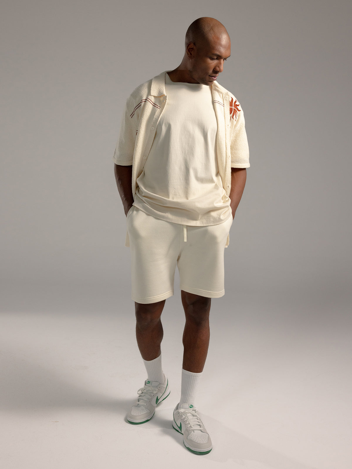 Man wearing Alabaster CityScape Shorts with grey background 