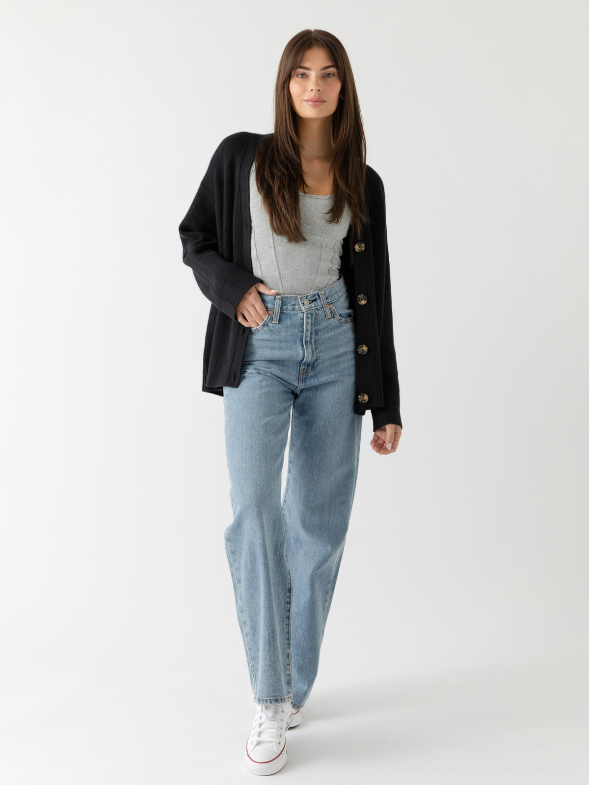 A woman wearing Cozy Earth Classic Cardigan in Black stands in front of a white background 