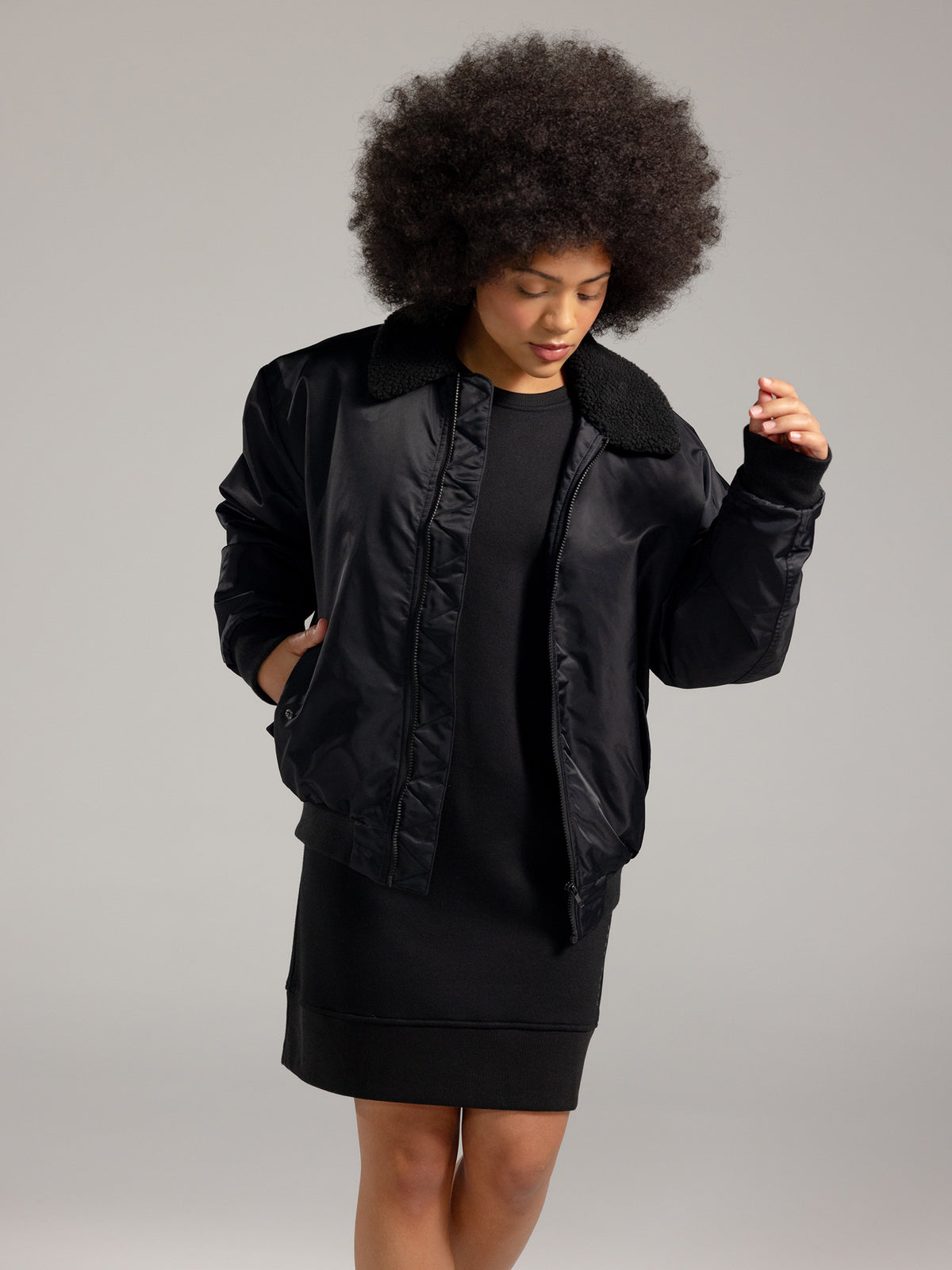 Woman wearing Black CityScape Crewneck Dress with grey background 