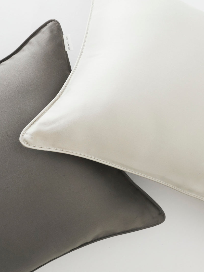 Close up of light grey and charcoal travel pillowcases