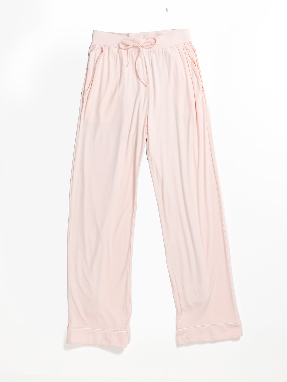 The Women's Stretch-Knit Bamboo Pajama Pant TALL by HIDE features a pair of light pink, soft fabric lounge pants with a drawstring waist and two side pockets. These pants have a relaxed, loose fit with folded hems and are made from smooth, flowy bamboo knit that is perfect for comfortable and casual wear. 